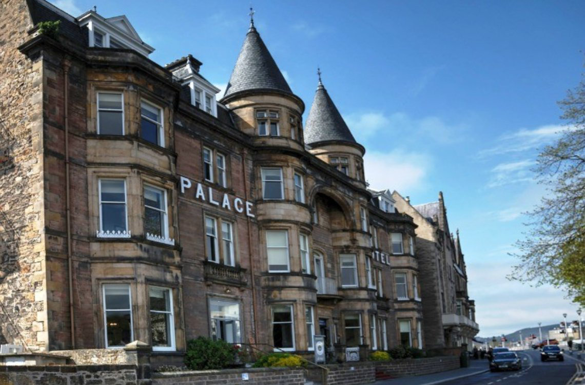 Best Western Palace Hotel, a grand stone building with twin turrets along the street in Inverness.