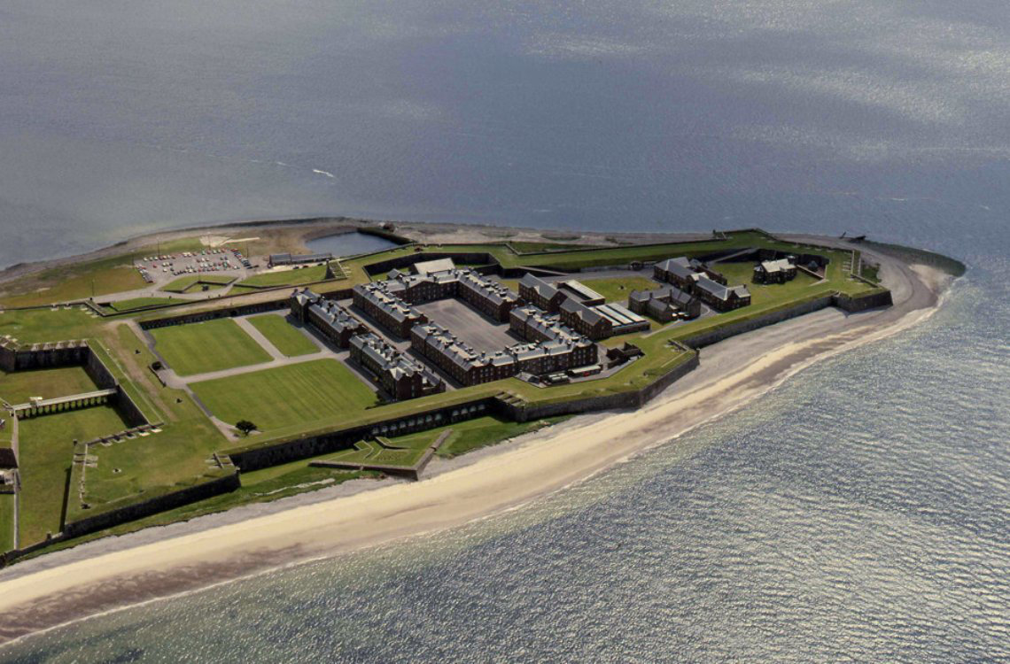 Fort George, large 18th-century military fortress on a coastal peninsula surrounded by sandy beach and sea.