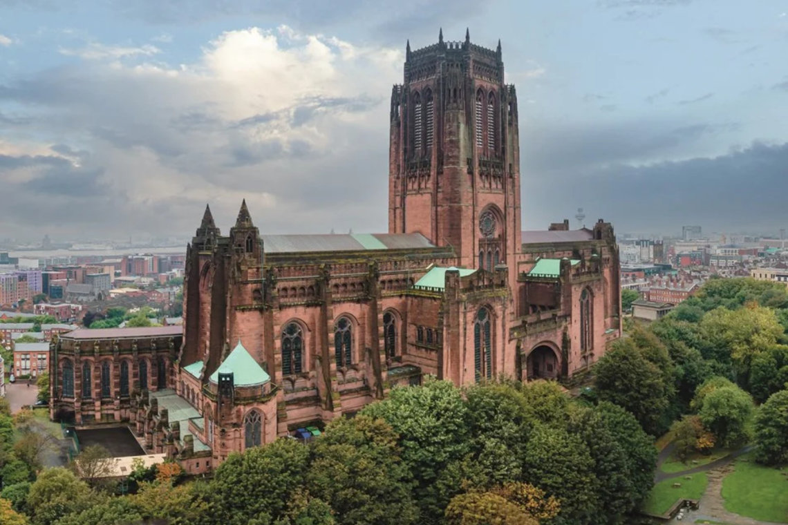 View of Liverpool Cathedral with red sandstone exterior and central tower overlooking the city.