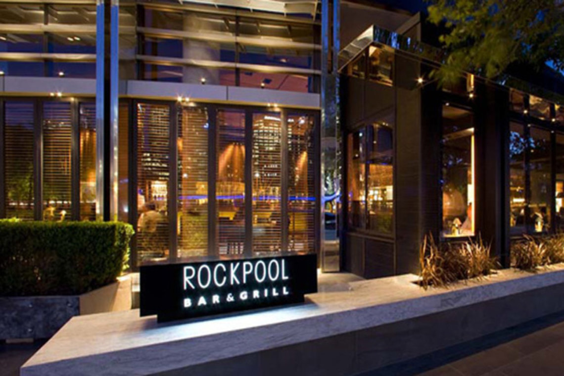 View of Rockpool Bar & Grill exterior with illuminated sign and modern design in Liverpool.